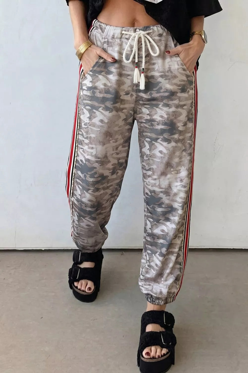 Camo print maternity pants with drawstring and side stripes, relaxed fit.