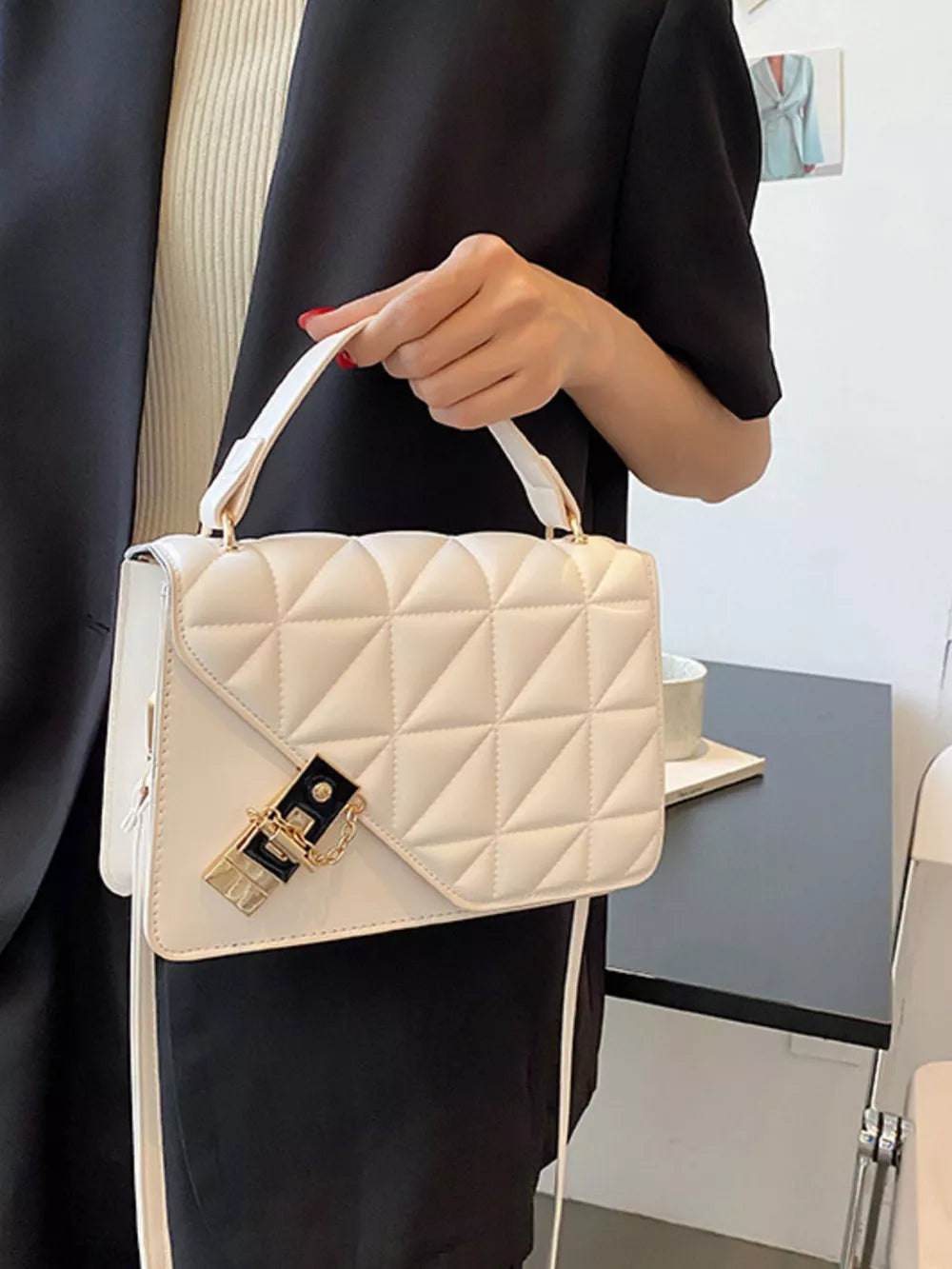 Diamond quilted PU leather crossbody bag in beige white with gold hardware and chain detail.