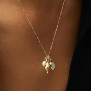 Gold seashell and gemstone charm necklace with pearl detail