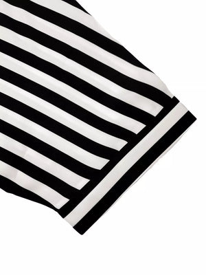 Black and white striped romper cover-up with collared neckline and button front detail.