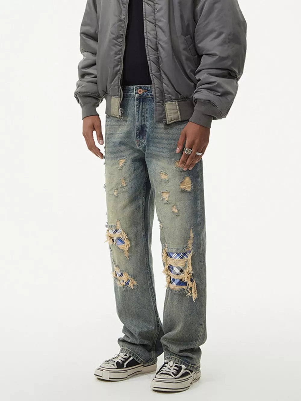 Distressed plaid wide leg jeans with ripped knees showing blue plaid patches.