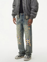 Distressed plaid wide leg jeans with ripped knees showing blue plaid patches.