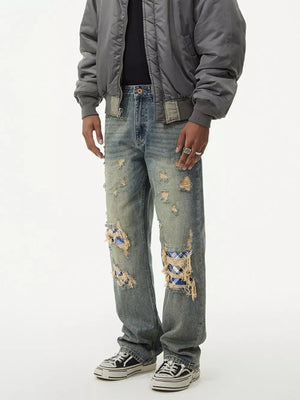 Distressed plaid wide leg jeans with ripped knees showing blue plaid patches.