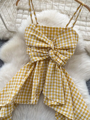 Yellow gingham cami top with twisted knot detail and asymmetrical hem.