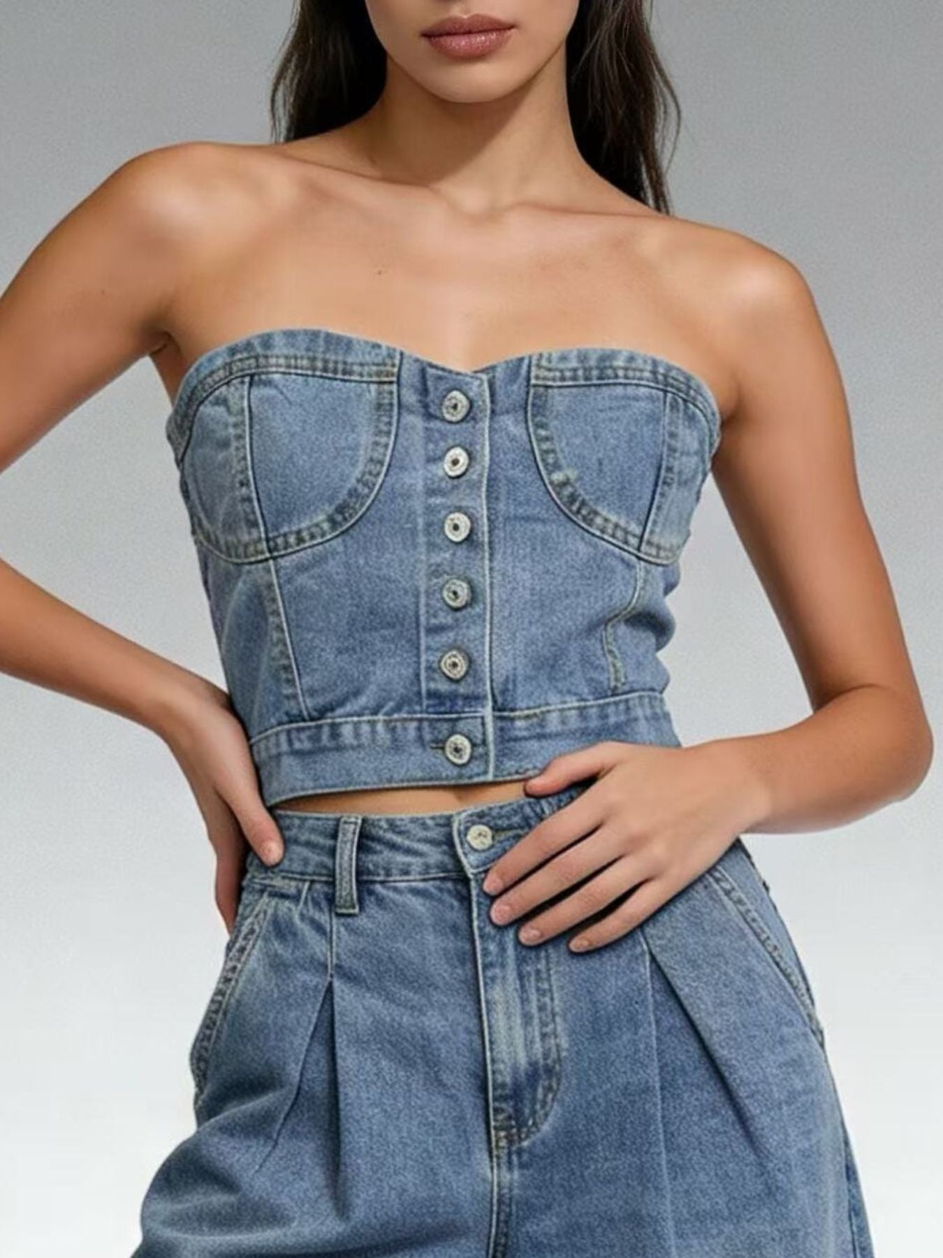 Structured denim tube top with button detail and sweetheart neckline, made of cotton.