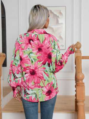 Blooms & Buttons shirt in light blue with a bold floral print and buttoned cuffs.