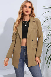 Tan double-breasted tailored blazer with flap pockets and a single button closure.