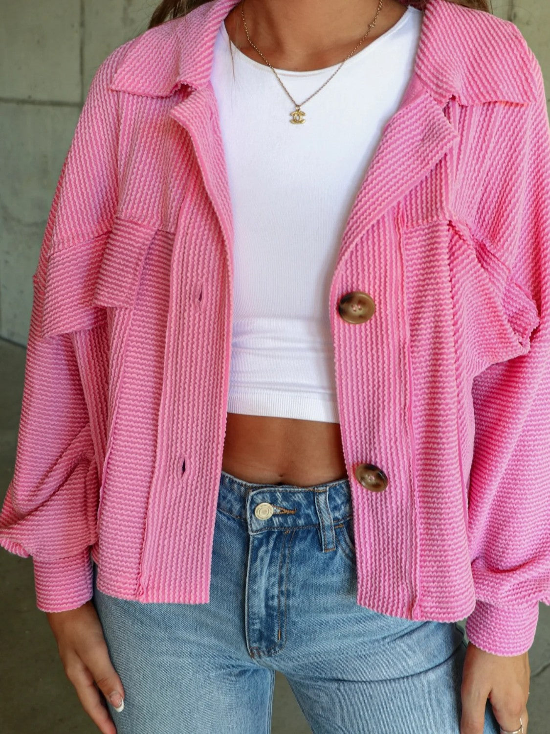 Textured boxy utility shirt jacket in Fuchsia Pink with button front and chest pockets.