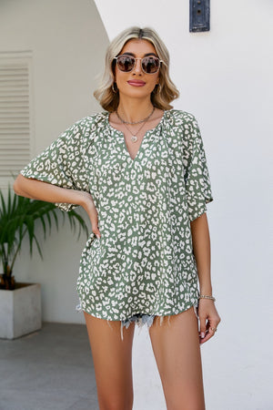 Army green leopard print v-neck blouse with short sleeves and a relaxed fit.