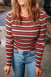 Ribbed knit crewneck sweater with horizontal red, white, and navy stripes.