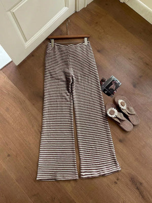 Striped wide leg maternity pants in dark brown with a comfortable knit fabric.