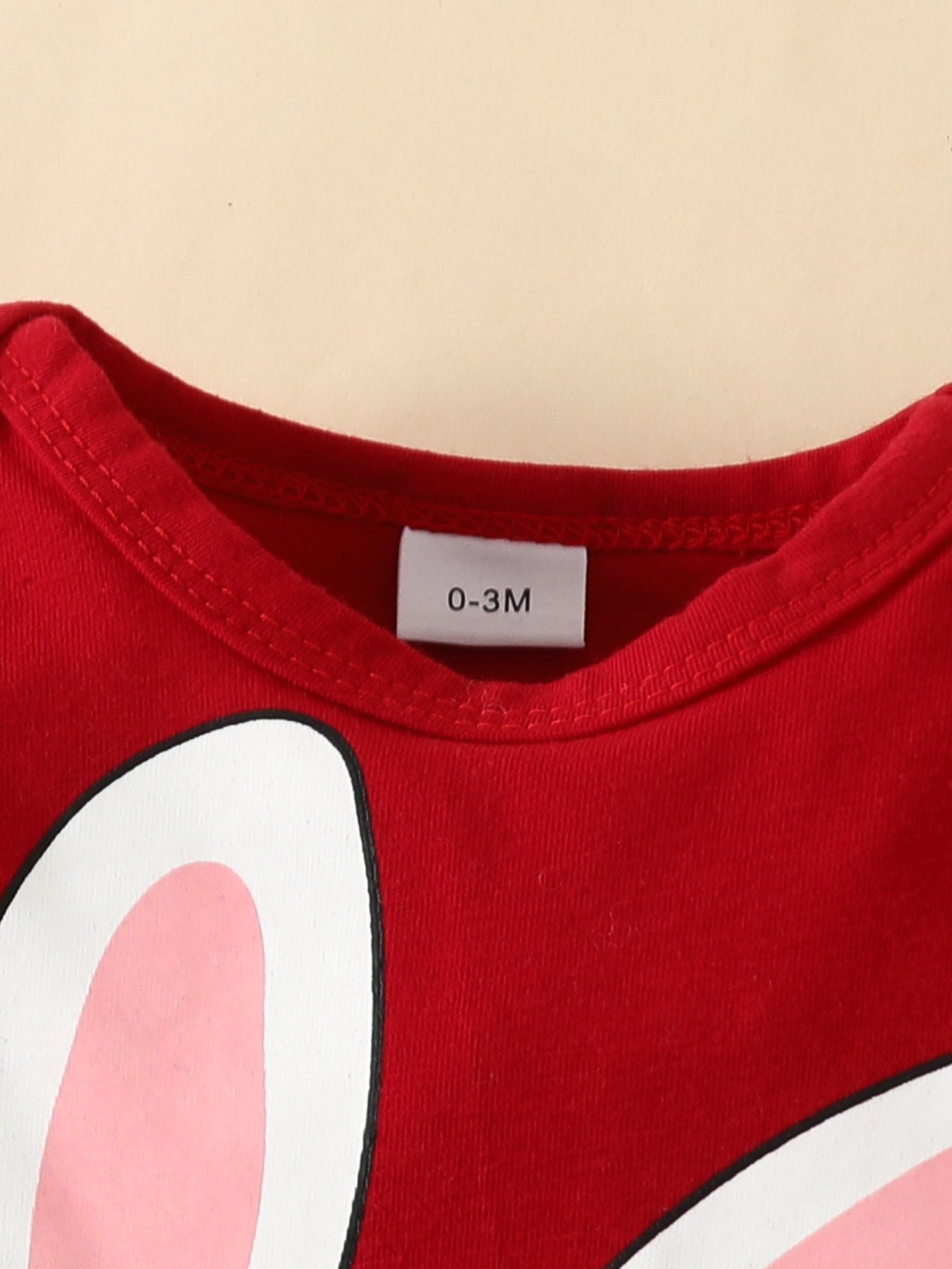 Red baby bodysuit with bunny ears graphic, 100% polyester