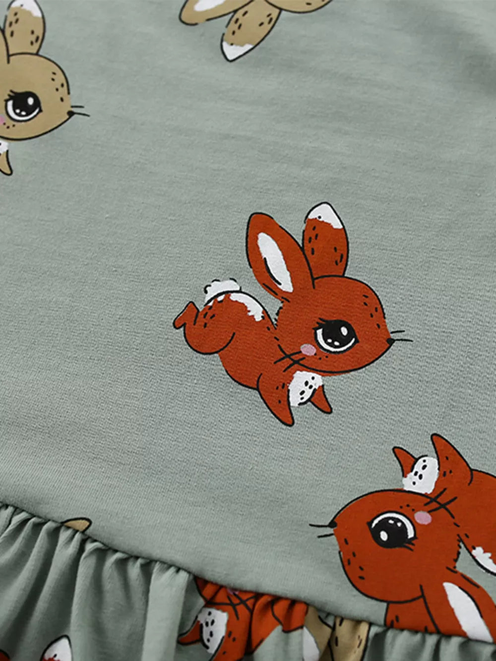 Baby dress in cotton blend with playful bunny print and ruffled hem.