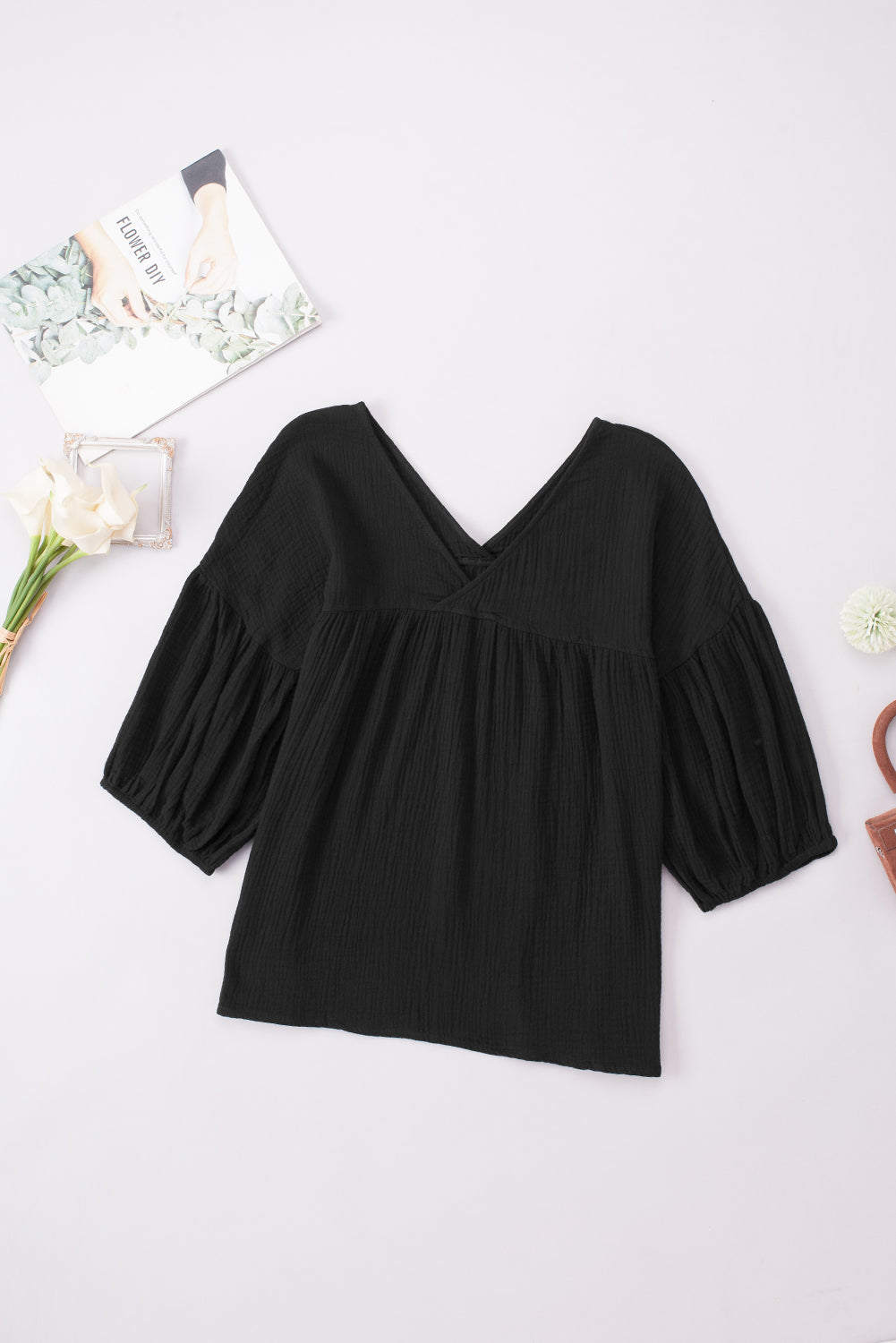 Black textured gauze blouse with V-neck and gathered puff sleeves