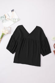 Black textured gauze blouse with V-neck and gathered puff sleeves