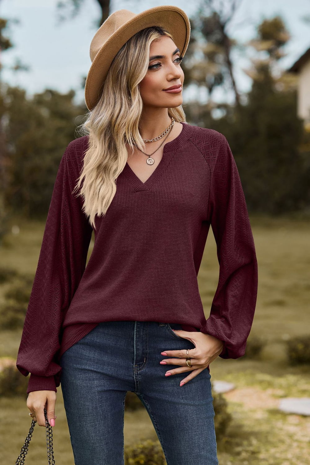 Burgundy waffle knit raglan sweater with laser cut sleeves and v-neck