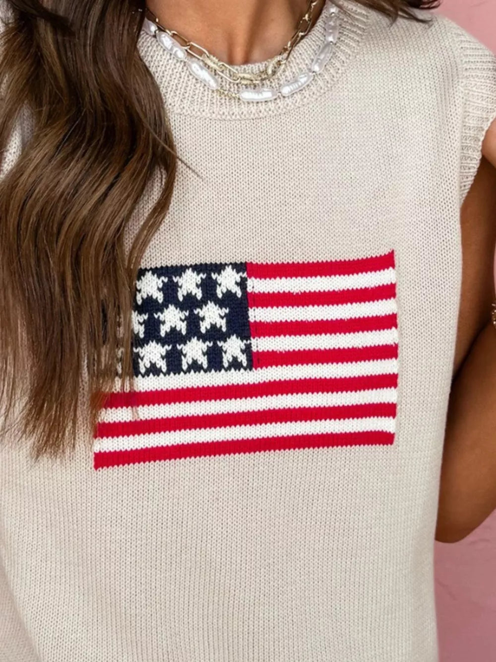Beige knit sweater vest with American flag design, crew neck, sleeveless.