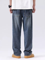 Men's blue vintage wash loose fit jeans with distressed detailing.