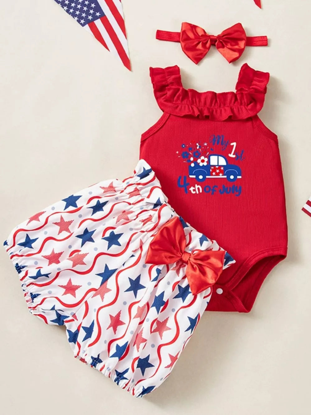 Red patriotic baby set with ruffled neckline, car graphic, and star bloomer shorts.