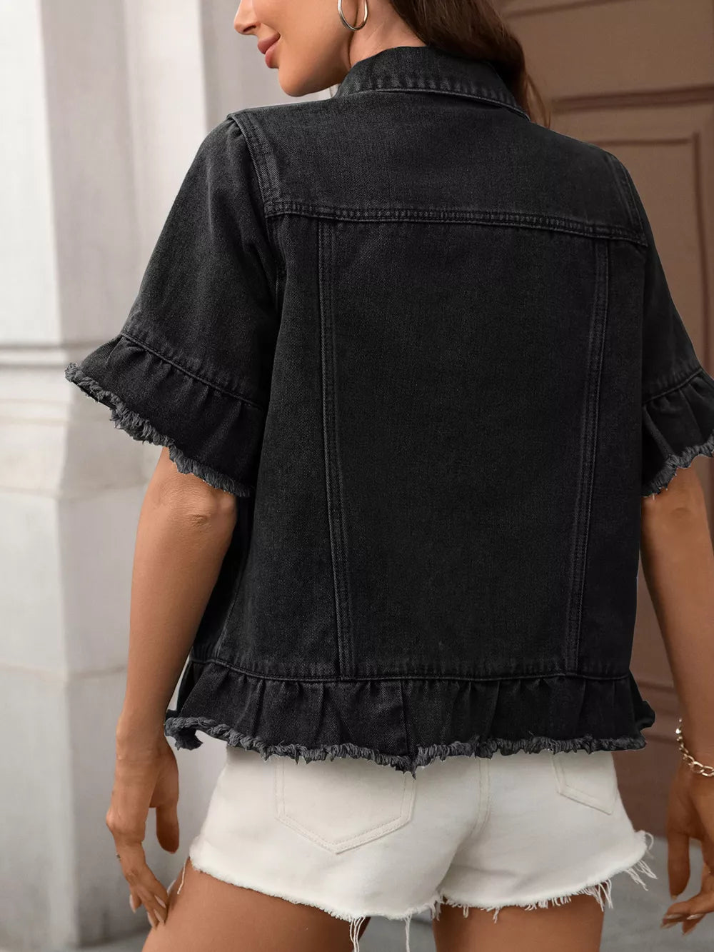 Black denim trucker jacket with short ruffled sleeves and raw hem