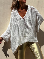 White open knit sweater with asymmetric hem and beaded trim, V-neck, long sleeves.