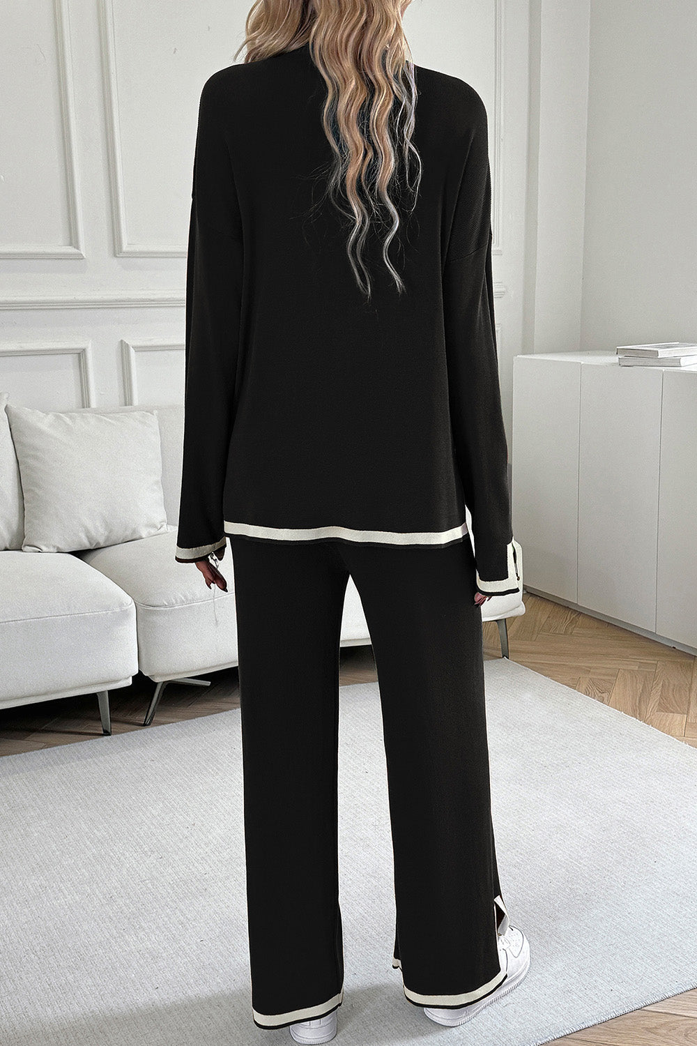 Black ribbed knit loungewear set with cream trim on cuffs and hem.