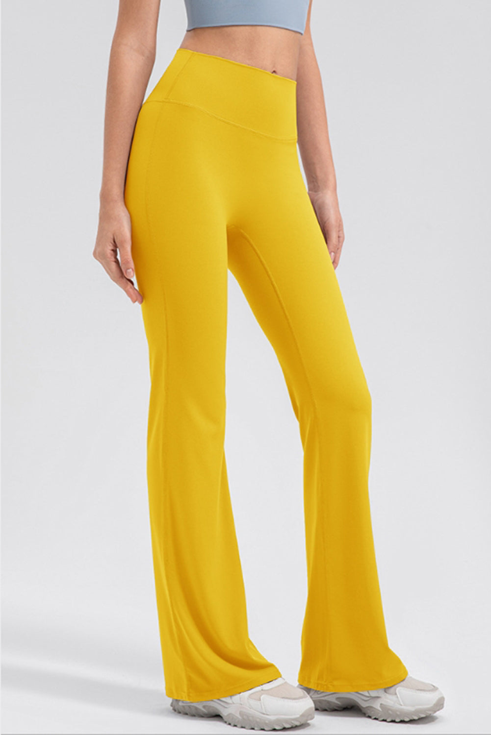 Yellow flare leggings with a high waist and performance fit.