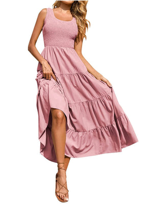 Blush pink smocked bodice ruffled maxi dress with tiered skirt and square neckline.