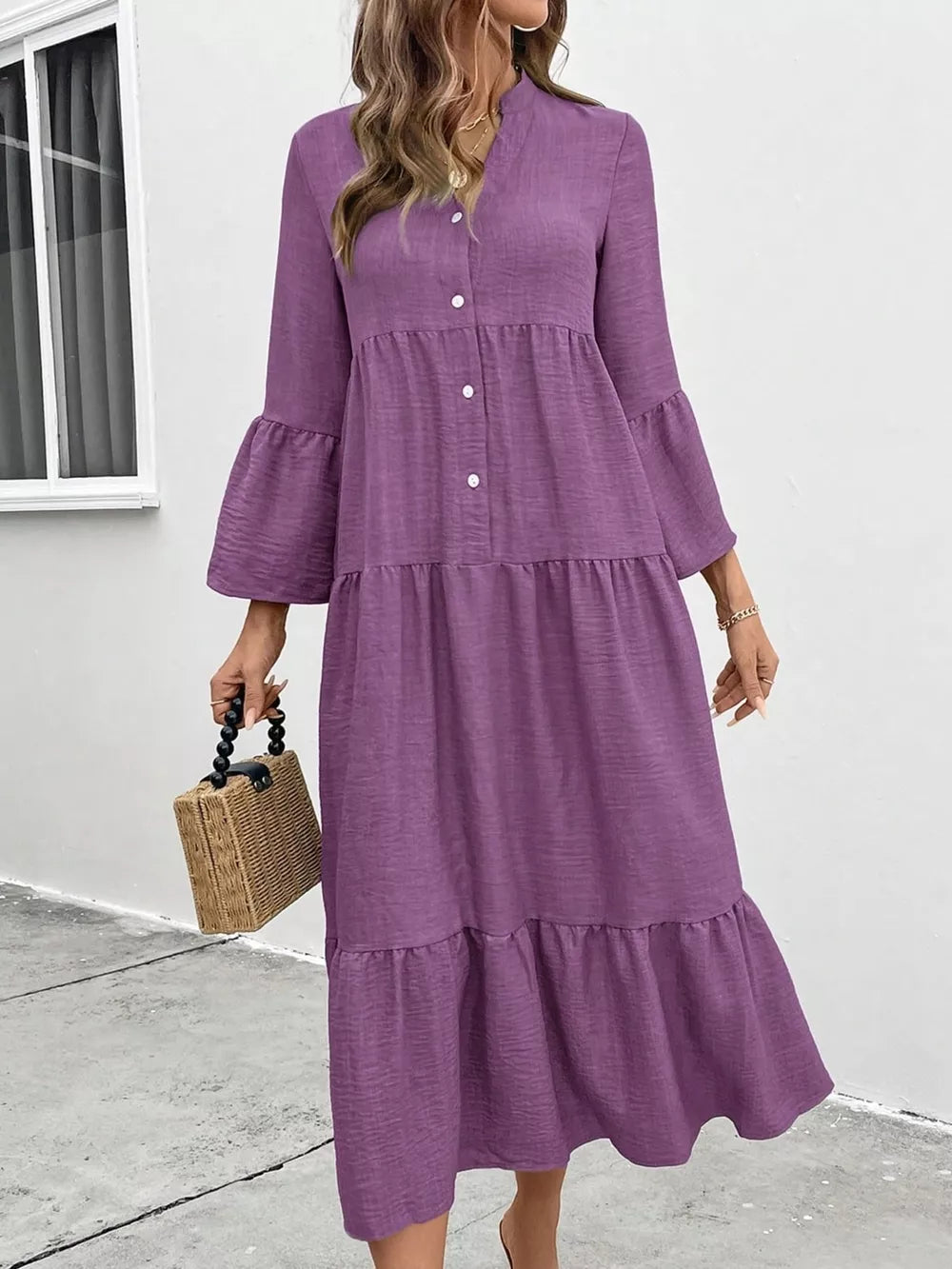 Purple tiered ruffle hem v-neck dress with button front and bell sleeves.
