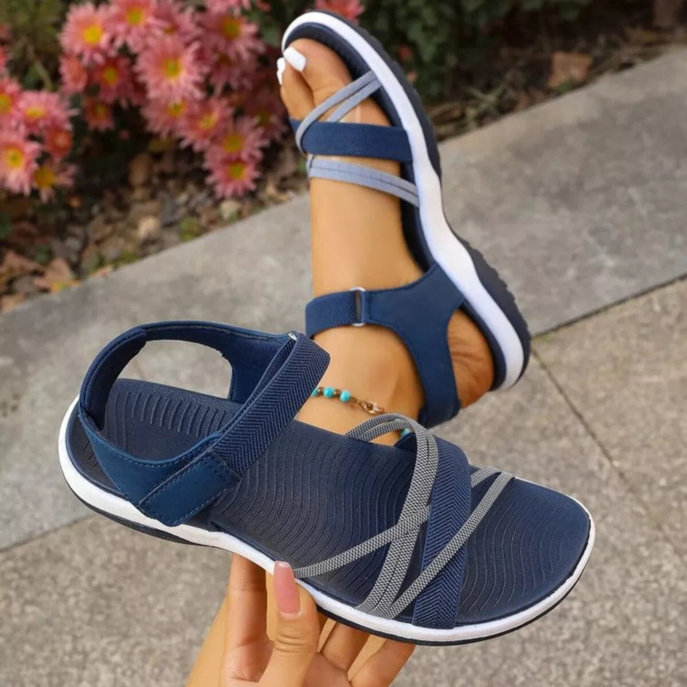 Blue criss-cross strap open-toe sandals with adjustable ankle strap.
