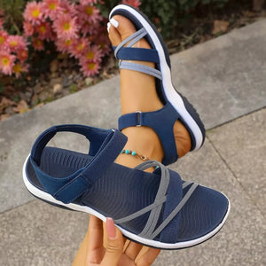 Blue criss-cross strap open-toe sandals with adjustable ankle strap.