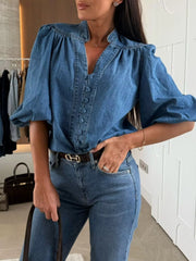 Denim button-down blouse with puff sleeves and a V-neckline.