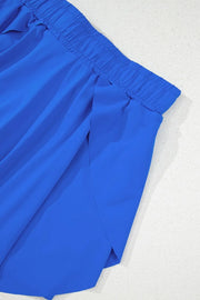 Blue flared skort with elastic waistband and tie detail.