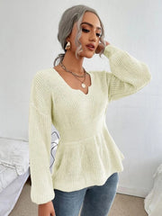 Ivory peplum knit sweater with scallop neckline and long sleeves.