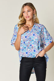 Floral ikat relaxed v-neck blouse in sky blue with short sleeves.