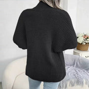 Black chunky knit dolman sleeve cardigan with a mock neck, shown from the back.