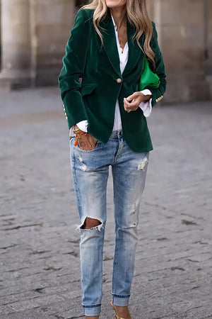 Velvet blazer in Black Forest green with gold button detail, styled with jeans.