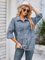 Oversized denim trucker jacket in dusty blue with rolled sleeves and button front.
