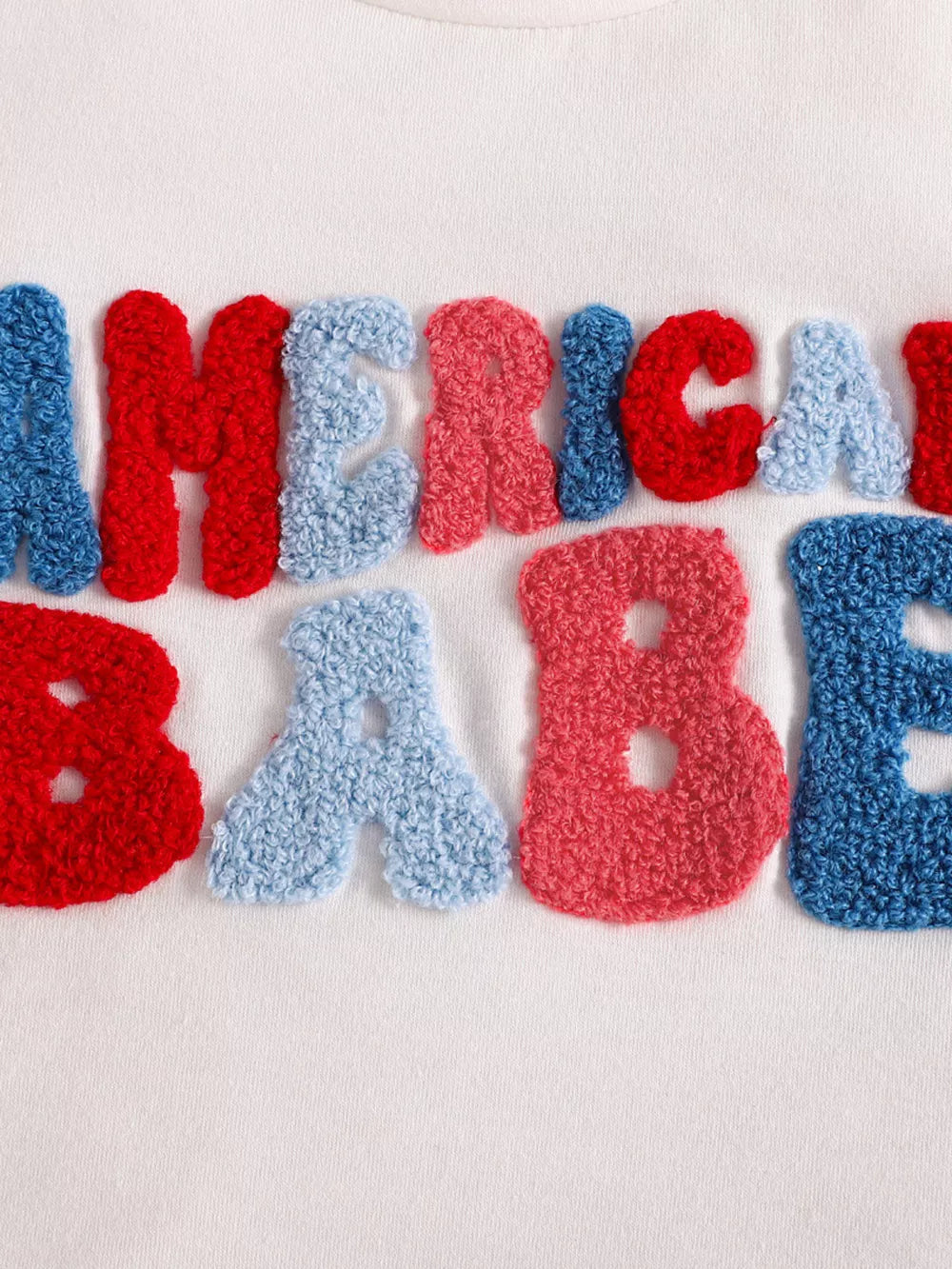 Patriotic toddler two-piece set with chenille letters spelling "AMERICA BABY" in red, white, and blue.