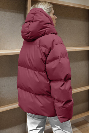 Burgundy oversized puffer jacket with hood and horizontal quilting detail.