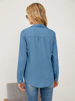 Light wash denim utility shirt with button cuffs and a curved hem.
