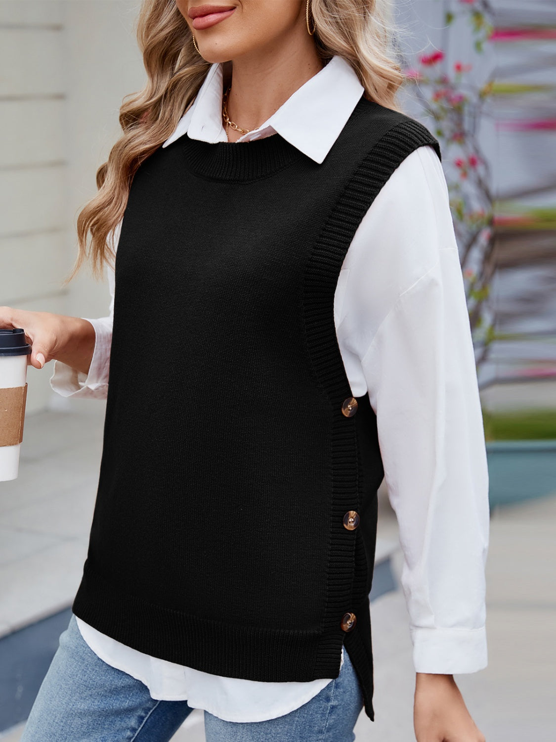 Black ribbed knit vest with side buttons, crew neck, sleeveless, acrylic material.
