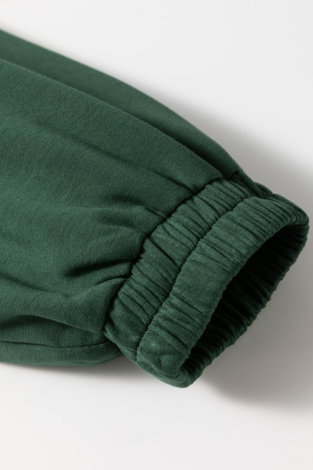 Dark green drawstring waist romper sleeve detail with elastic cuff