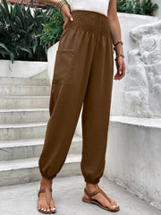 Brown relaxed-fit trousers with smocked waistline and cargo pocket detail