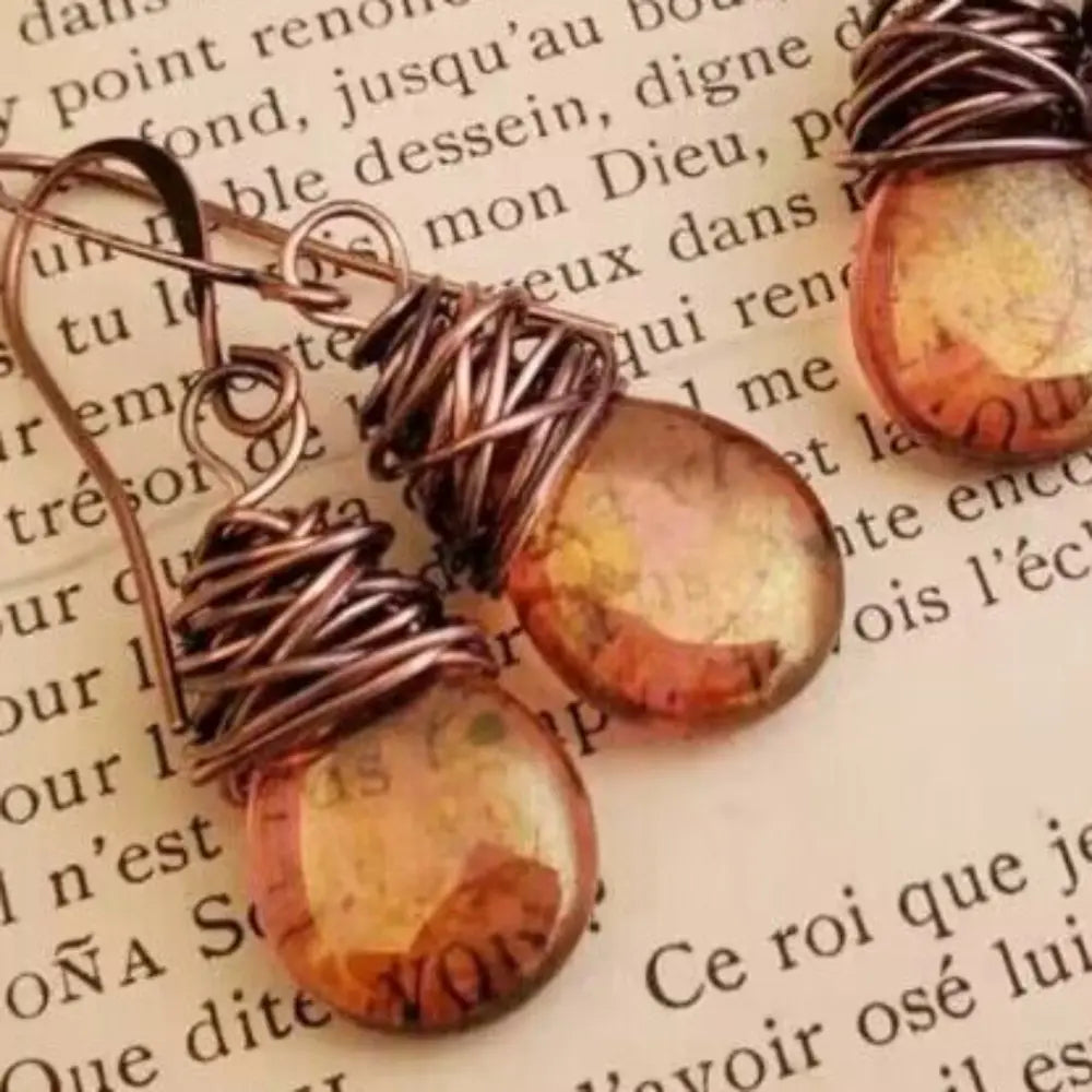 Wrapped wire teardrop earrings with amber glass beads and copper wire accents.