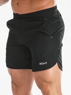Black athletic shorts with white logo detail and side slits.