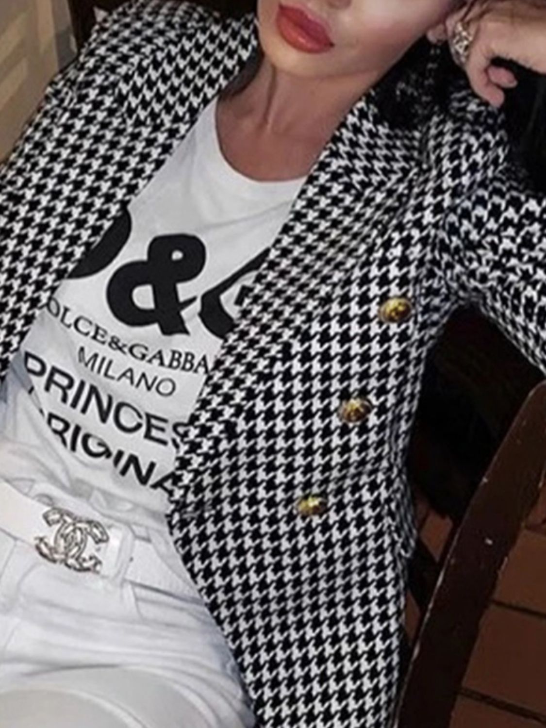 Houndstooth double-breasted blazer with gold buttons and a collar.