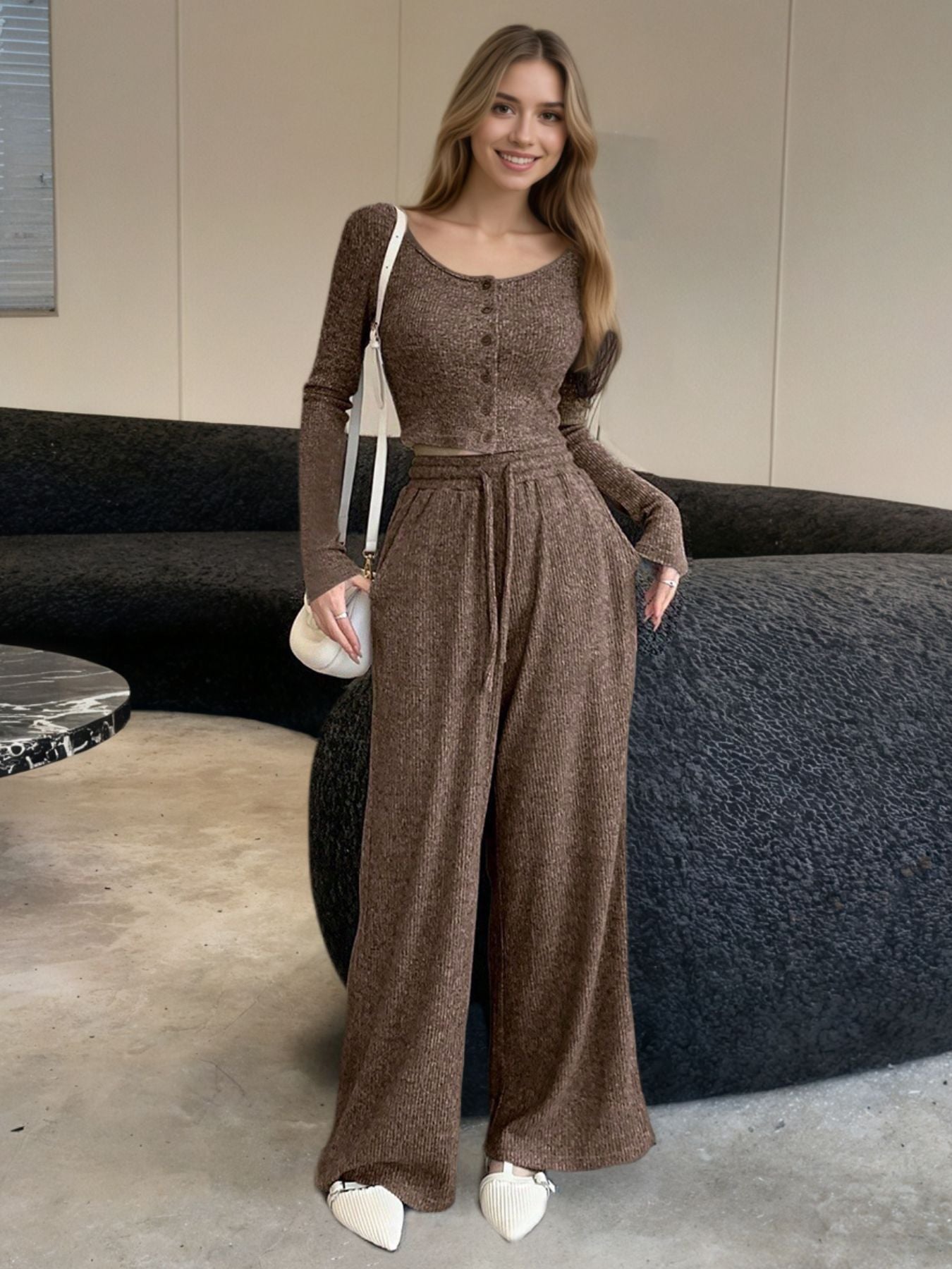 Brown ribbed knit two-piece set with button-down crop top and drawstring wide-leg pants.