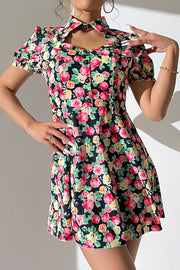Floral mini dress with keyhole neckline, puff sleeves, and button front.