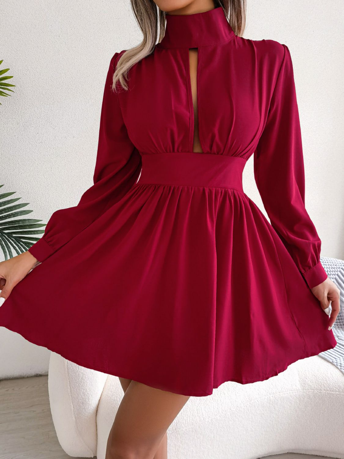 Red fit-and-flare mini dress with keyhole neckline, long sleeves, and cinched waist.